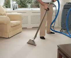 Carpet cleaning professional removing dirt and stains with a hot-water extraction tool in a home, Yonkers, NY.